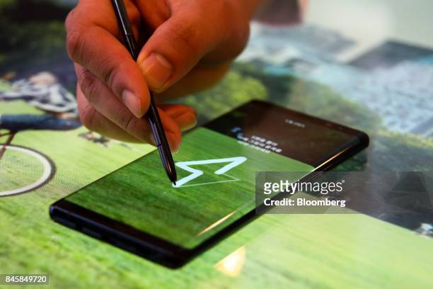 An attendee demonstrates the S Pen stylus with the Samsung Electronics Co. Galaxy Note 8 smartphone during a media event in Seoul, South Korea, on...