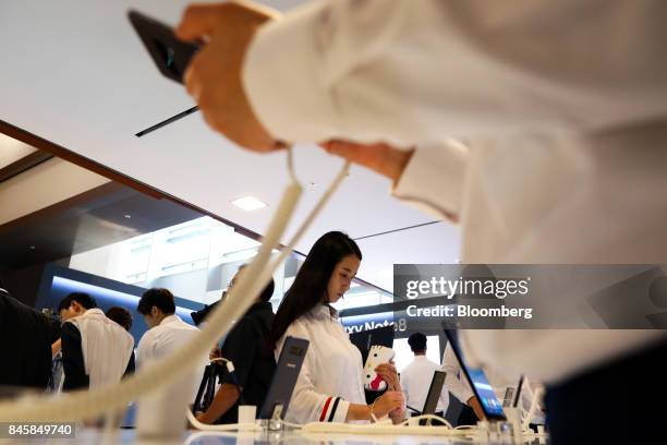 Attendees try out Samsung Electronics Co. Galaxy Note 8 smartphones during a media event in Seoul, South Korea, on Tuesday, Sept. 12, 2017. Samsung's...