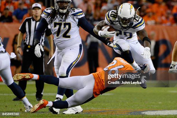 Jamaal Charles of the Denver Broncos is tackled by Darian Stewart of the Denver Broncos during the second quarter on Monday, September 11, 2017. The...