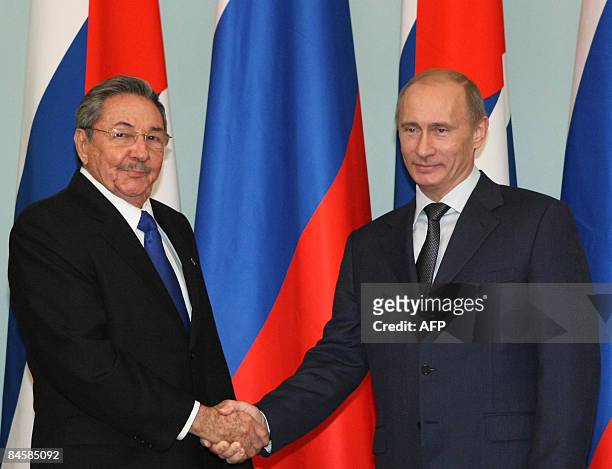 Russian Prime Minister Vladimir Putin shakes hands with Cuban President Raul Castro in Moscow on February 2, 2009. Castro is on a week long visit to...