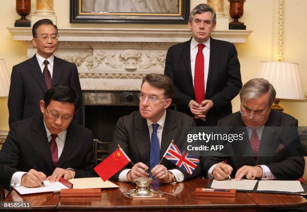 British Prime Minister Gordon Brown and Chinese Premier Wen Jiabao witness the signing of trade agreements, monitored by Secretary of State for...