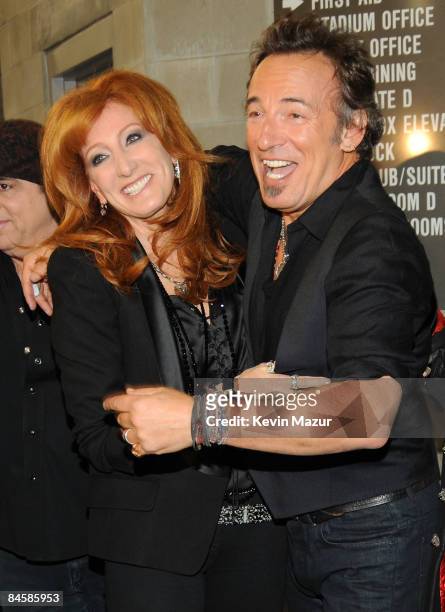 Musicians Patti Scialfa and Bruce Springsteen of the E Street Band perform at the Bridgestone halftime show during Super Bowl XLIII between the...