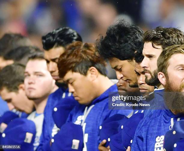 Los Angeles Dodgers players observe a moment of silence before a game against the San Francisco Giants at AT&amp;T Park in San Francisco on Sept. 11...