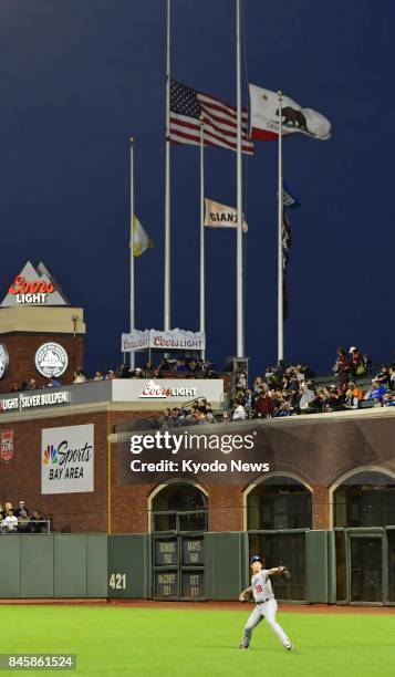 The U.S., California and San Francisco Giants flags fly at half-mast at AT&amp;T Park in San Francisco on Sept. 11 the 16th anniversary of the...