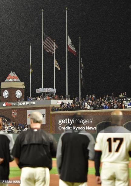 The U.S., California and San Francisco Giants flags fly at half-mast at AT&amp;T Park in San Francisco on Sept. 11 the 16th anniversary of the...