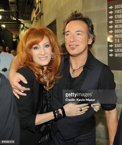 Singer Patti Scialfa and musician Bruce Springsteen pose backstage at the Bridgestone halftime show during Super Bowl XLIII between the Arizona...