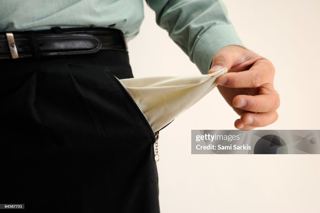 Businessman showing out an empty pant's pocket