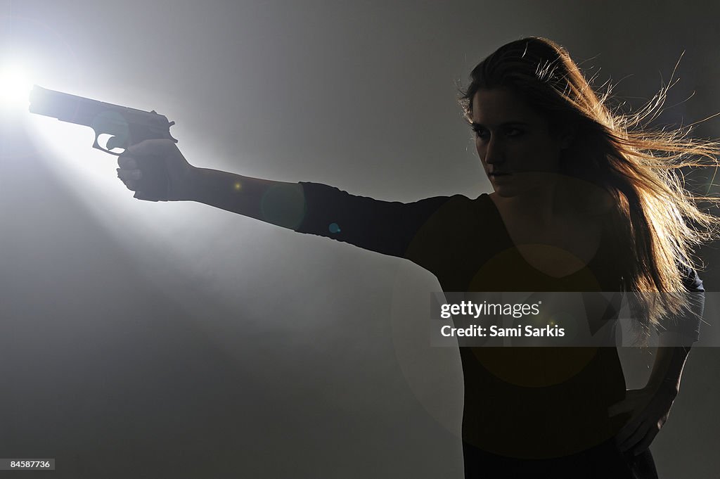 Young woman holding gun