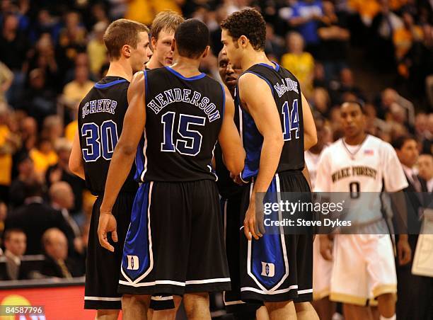 Jon Scheyer, Kyle Singler, Gerald Henderson, Nolan Smith and David McClure of the Duke Blue Devils huddle during a break in the play in the second...