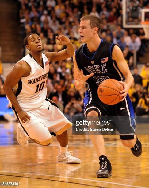 Jon Scheyer of the Duke Blue Devils dribbles the ball upcourt on Ishmael Smith the Wake Forest Demon Deacons in the second half of the game at...