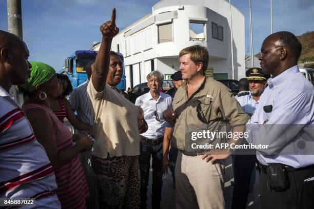 Dutch King Willem-Alexander listens to inhabitants as he visits Dutch Caribbean island of Sint Maarten on September 11, 2017 after hurricane Irma...