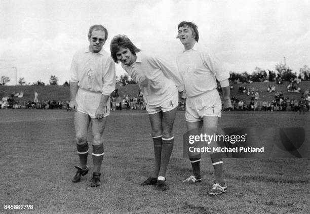 Celebrity football fans Elton John, Rod Stewart and Michael Parkinson take part in a charity football match, UK, 1974.
