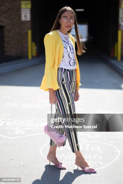 Caroline Vazzana is seen attending Hakan Akkaya during New York Fashion Week wearing Yeah Bunny pants, Nina Shoes, Lauren Cecchi bag, Brandy Melville...
