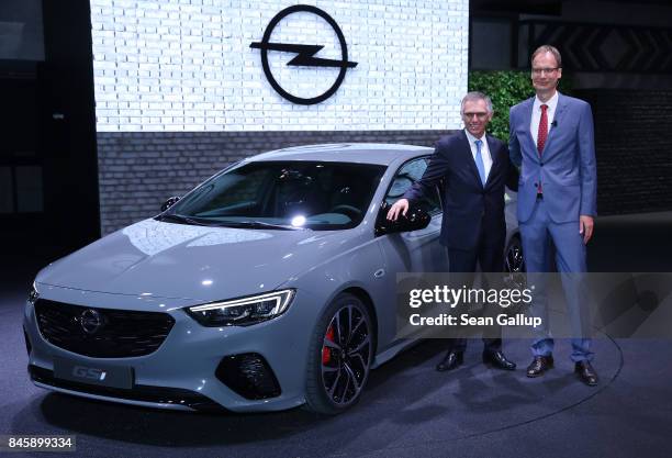 Michael Lohscheller , CEO of German carmaker Opel, and Carlos Tavares, Chairman of PSA Peugeot Citroen, stand next to a 2017 Opel Insignia GSi at the...