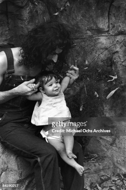Rock and roll guitariist Frank Zappa poses for a portrait in Laurel Canyon with his daughter Moon Unit Zappa in February 1968 in Los Angeles,...