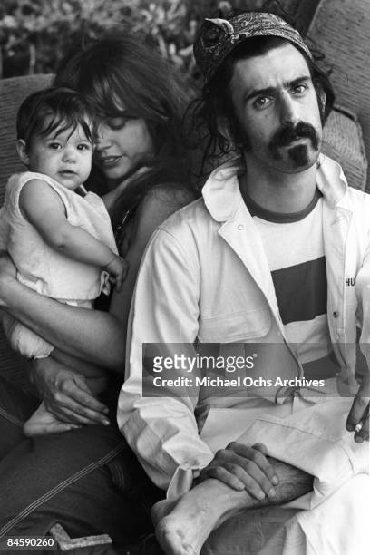 Rock and roll guitariist Frank Zappa poses for a portrait in Laurel Canyon with his wife Gail Zappa and daughter Moon Unit Zappa in February 1968 in...