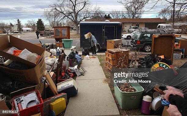 Tracy Munch collects some belongings after an eviction team removed the furniture from her foreclosed house on February 2, 2009 in Adams County,...