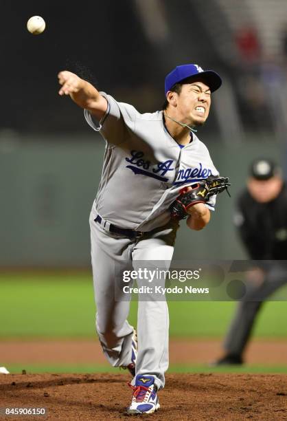 Kenta Maeda of the Los Angeles Dodgers pitches against the San Francisco Giants at AT&amp;T Park in San Francisco on Sept. 11 after a lengthy rain...