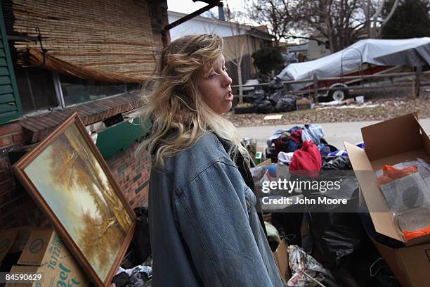 Tracy Munch looks over her belongings after an eviction team removed the furniture from her foreclosed house on February 2, 2009 in Adams County,...