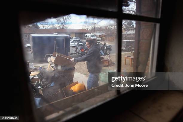 An eviction team carries out a family's belongings during a foreclosure eviction February 2, 2009 in Adams County, Colorado. The family had been...