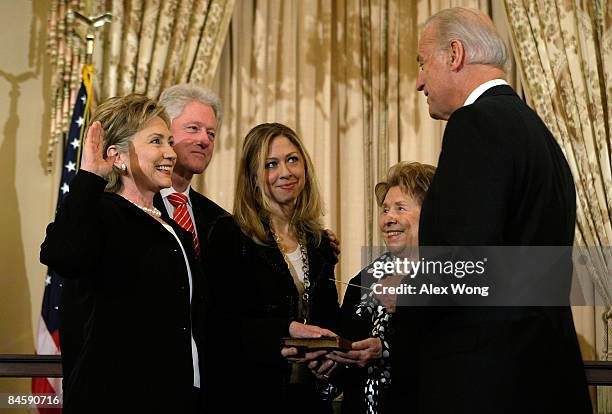 Secretary of State Hillary Clinton is sworn in by Vice President Joseph Biden as her husband former President Bill Clinton , her daughter Chelsea and...