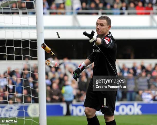 Goalkeeper Paddy Kenny of QPR clearing missiles thrown during the NPower Championship match between Queens Park Rangers and Crystal Palace at Loftus...