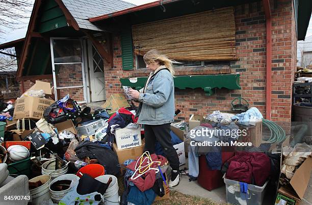 Tracy Munch looks over an album of familiy photos after an eviction team removed all of her possessions from her foreclosed house on February 2, 2009...
