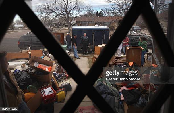 Adams Country sheriff's deputy Greg Barnett , looks on after an eviction team carried out a family's belongings during a foreclosure eviction...