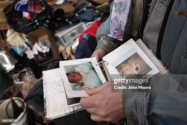 Tracy Munch looks over an album of familiy photos after an eviction team removed all of her possessions from her foreclosed house on February 2, 2009...