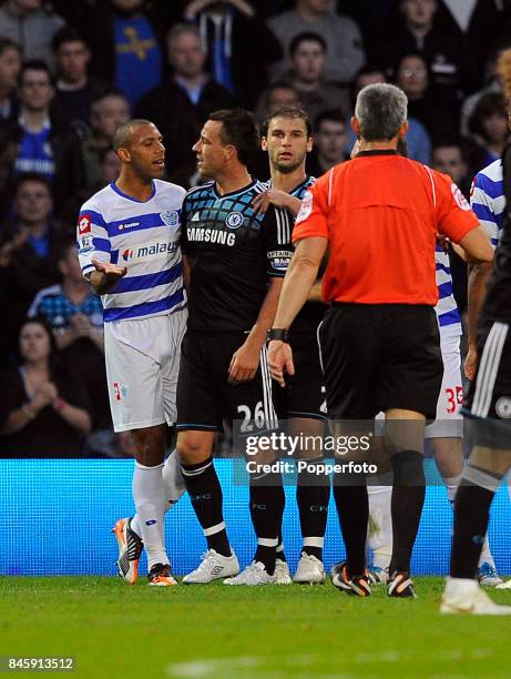 John Terry of Chelsea clashes with Anton Ferdinand of QPR during the Barclays Premiership match between Queens Park Rangers and Chelsea at Loftus...