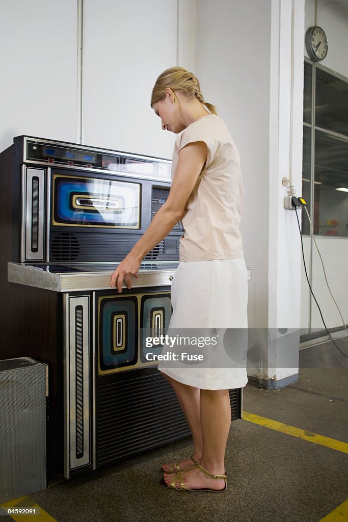 Businesswoman Using Jukebox