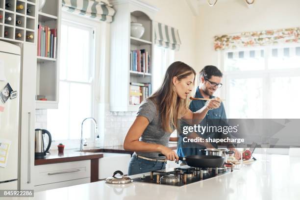 she's the official taste tester - young couple cooking stock pictures, royalty-free photos & images