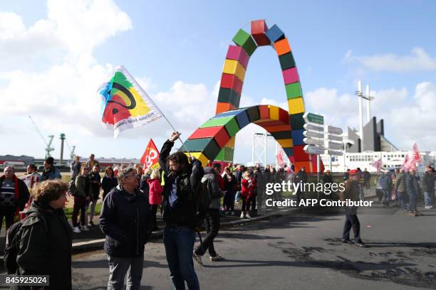 People take part in a protest called by several French unions against the labour law reform at the harbour of Le Havre on September 12, 2017. French...