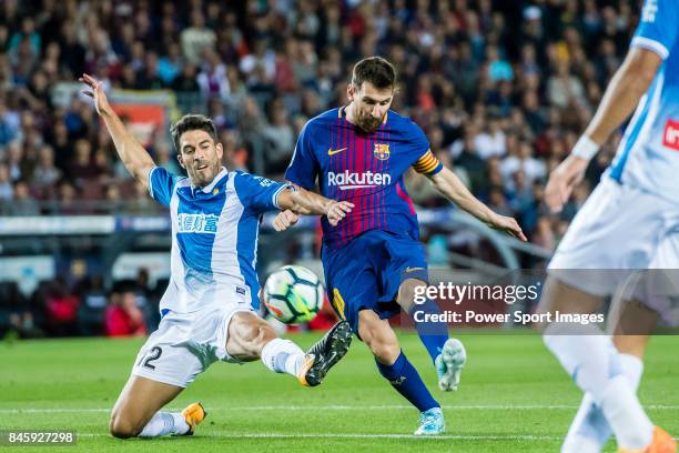 Lionel Andres Messi of FC Barcelona fights for the ball with Didac Vila Rossello of RCD Espanyol during the La Liga match between FC Barcelona vs RCD...