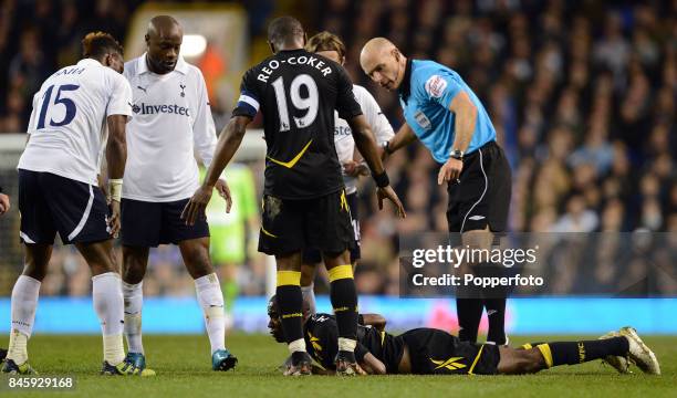 Referee Howard Webb stands over Fabrice Muamba of Bolton who is lying on the ground awaiting medical treatment after suffering a heart attack during...