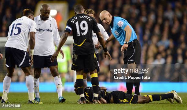 Referee Howard Webb stands over Fabrice Muamba of Bolton who is lying on the ground awaiting medical treatment after suffering a heart attack during...