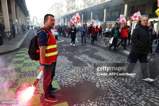 Demonstrators take part in a protest called by several French unions against the labour law reform at the harbour of Le Havre on September 12, 2017....