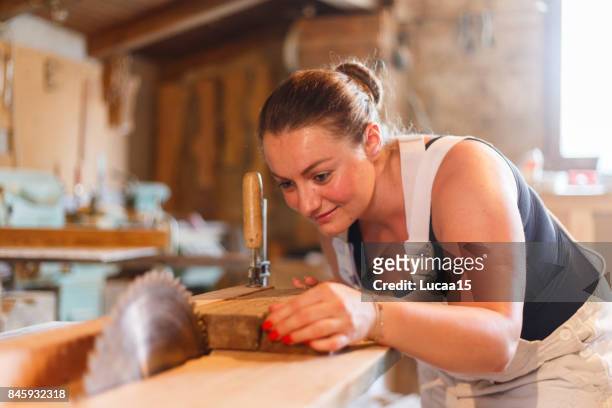 carpenters sawing - berufliche beschäftigung stock pictures, royalty-free photos & images