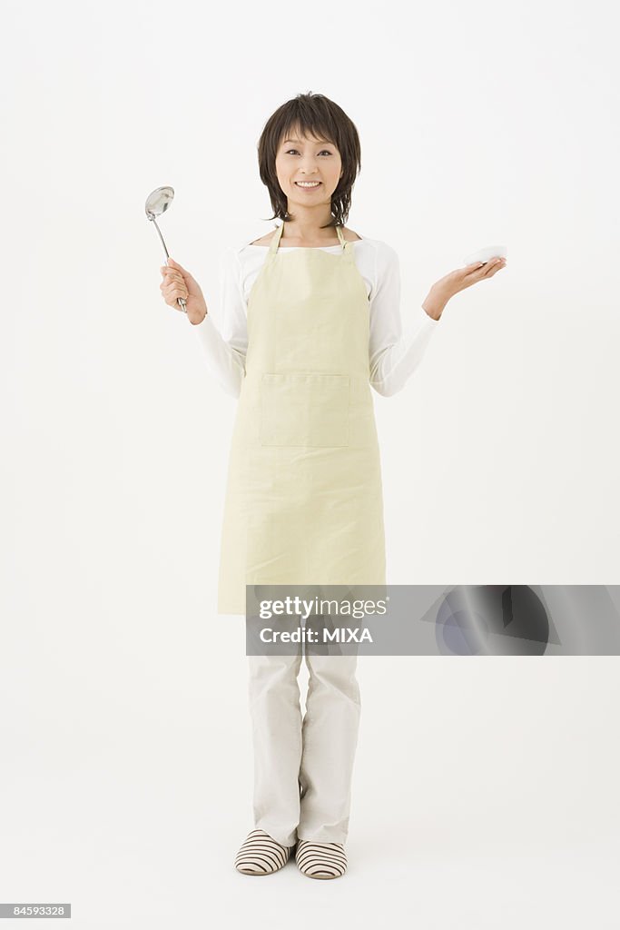 Young woman holding ladle