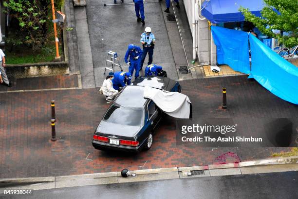 Police officers investigate the fatal shooting of a suspected Yakuza gangster on September 12, 2017 in Kobe, Hyogo, Japan. The man who was shot in a...