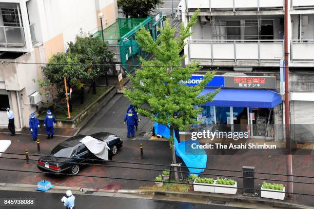 Police officers investigate the fatal shooting of a suspected Yakuza gangster on September 12, 2017 in Kobe, Hyogo, Japan. The man who was shot in a...