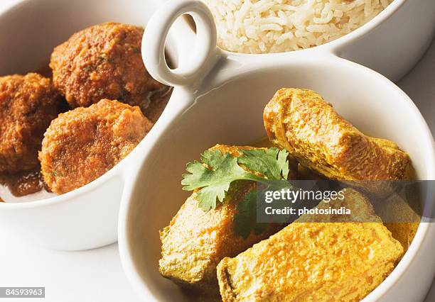 close-up of boiled rice and meatballs with fish curry served in bowls - indian food bowls stock-fotos und bilder