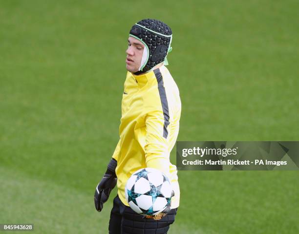 Manchester City goalkeeper Ederson wears a protective helmet during the training session at the City Football Academy, Manchester.