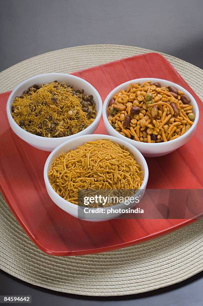 high angle view of various type of snacks in bowls - indian food bowls stock-fotos und bilder