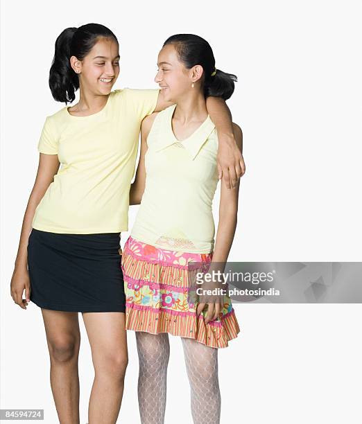 teenage girl smiling with her sister - 12 year old in skirt stock pictures, royalty-free photos & images