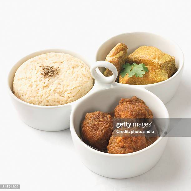 close-up of boiled rice and meatballs with fish curry served in bowls - indian food bowls stock-fotos und bilder