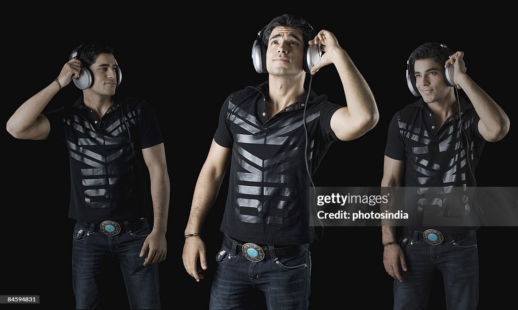 Young man wearing headphones and listening to music