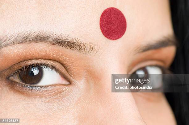 close-up of a young woman's eyes - bindi stock-fotos und bilder
