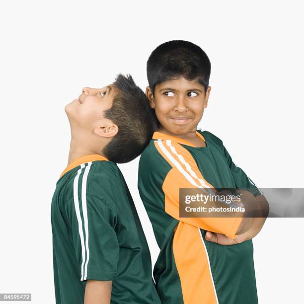 two boys standing back to back - smirk stock pictures, royalty-free photos & images