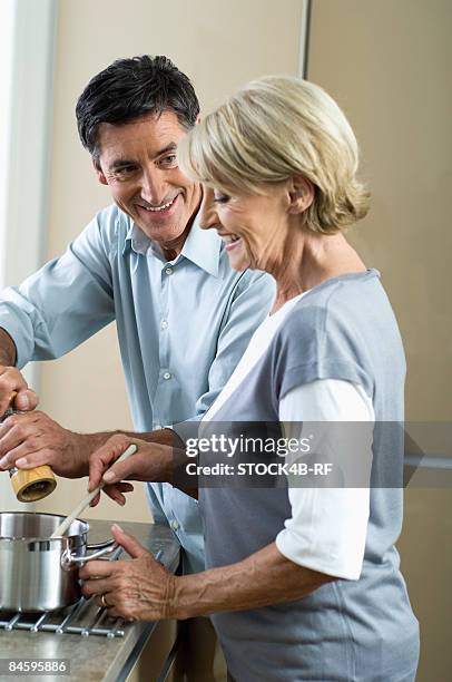 couple cooking together - pepper mill stock pictures, royalty-free photos & images